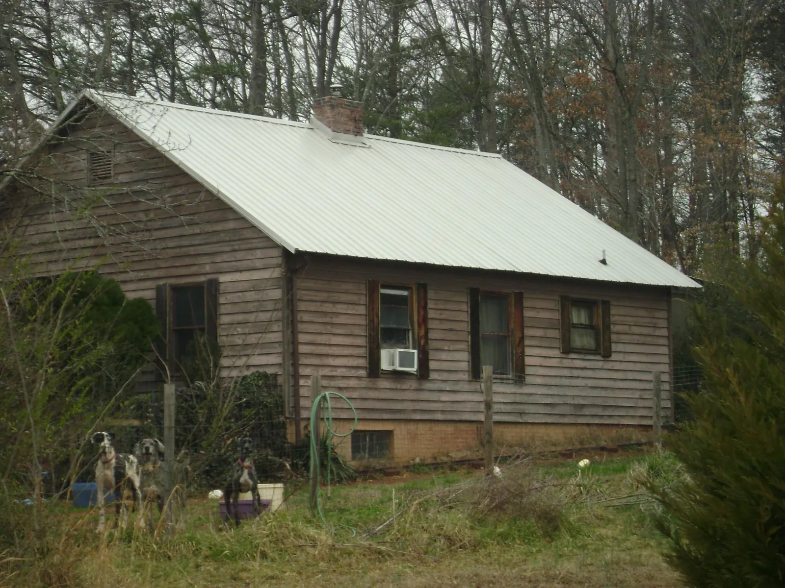 White metal roof on an old wood sided farmhouse, from a Metal Roof Installation job in Gratz